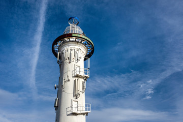 Austria, Vienna, near Donauinsel: Famous white light house from below near Danube river of the Austrian capital with blue cloudy sky in the background - concept architecture viewing platform history