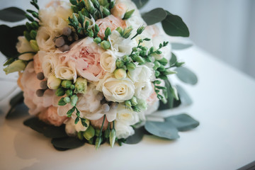 beautiful wedding bouquet. Stylish wedding bouquet bride of pink roses, white carnation and green flowers. Side view. Wedding decor.