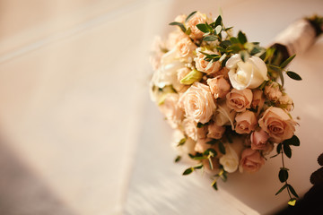 beautiful wedding bouquet. Stylish wedding bouquet bride of pink roses, white carnation and green flowers. Side view. Wedding decor.