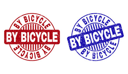 Grunge BY BICYCLE round stamp seals isolated on a white background. Round seals with grunge texture in red and blue colors. Vector rubber watermark of BY BICYCLE label inside circle form with stripes.