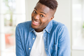 Handsome african young man smiling cheerful with a big smile on face