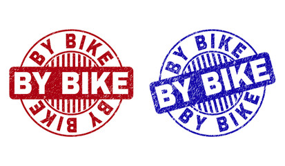 Grunge BY BIKE round stamp seals isolated on a white background. Round seals with grunge texture in red and blue colors. Vector rubber imitation of BY BIKE title inside circle form with stripes.