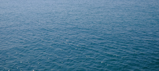 blue sea surface with wave and wind
