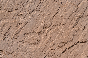 Brownish concrete wall with a rough surface as background