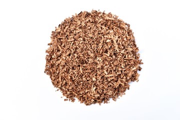 pile of brown wood saw dust om white background