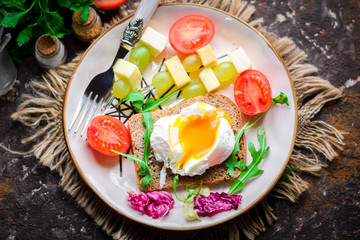 Sandwiches of rye bread with poached eggs.