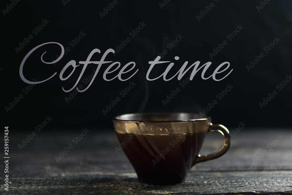 Wall mural hot brewed coffee with steam from a mug on a dark background