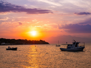 Fototapeta na wymiar Wonderful sunset in Thasos island, Greece as seen from the shore at Prinos town