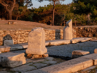 Old ruins and stones carved in the old greek language at the archeological site near Aliki Marble Port on Thasos Island, Greece