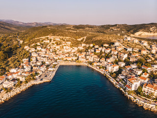 Skala Marion beach and harbour in Thasos Island, Greece. Sunset view shot using a drone