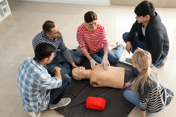 People learning to perform CPR at first aid training course