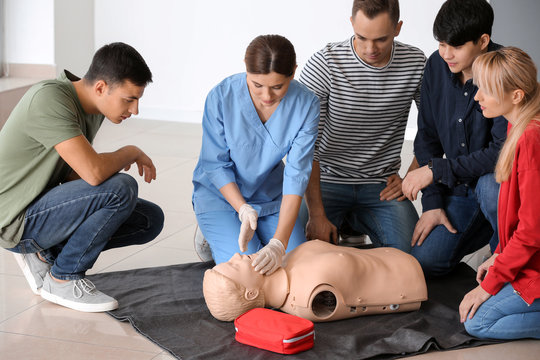 People learning to perform CPR at first aid training course