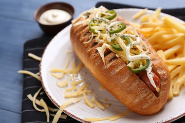 Tasty hot dog on plate, closeup