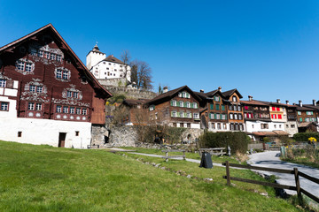 Werdenberg, SG / Switzerland - March 31, 2019: historic Werdenberg village and castle with traditional Burgher homes with wall art and painting