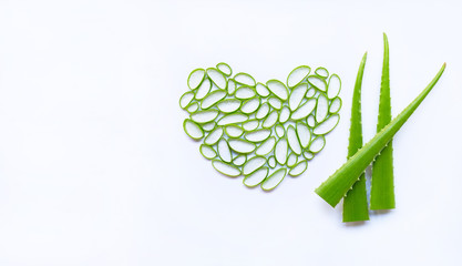 Aloe vera slices heart shape and aloe vera leaves on white background.