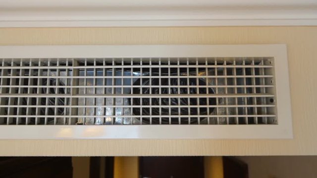 Central air conditioning cooling system. Air conditioner linear slot diffuser on apartment wall.