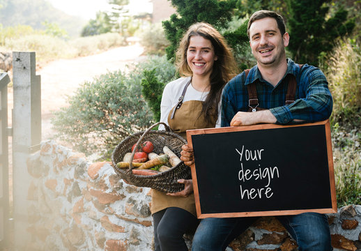 Blackboard Mockup with 2 People with Aprons and a Basket of Vegetables