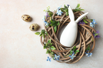 nest with quail eggs and white Easter bunny