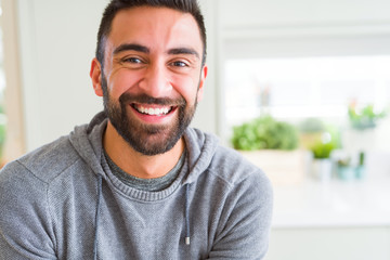 Handsome man smiling cheerful with a big smile on face showing teeth, positive and happy expression