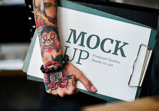 Tattooed Hand Holding Clipboard Mockup