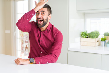 Handsome hispanic business man surprised with hand on head for mistake, remember error. Forgot, bad...