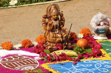 View of Indian Hindu rangoli drawn with decoration with Hindu goddess lakshmi idol during Pongal,...