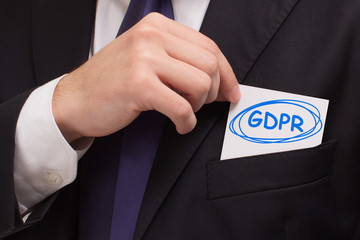 Business, technology, internet and networking concept. Young entrepreneur showing keyword: GDPR
