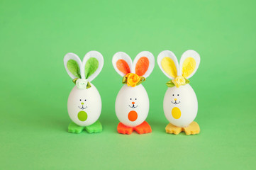 Easter holiday concept with cute handmade funny eggs bunny