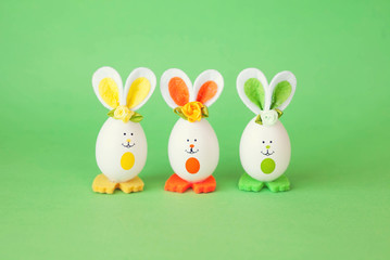 Easter holiday concept with cute handmade funny eggs bunny