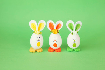 Easter holiday concept with cute handmade funny eggs bunny