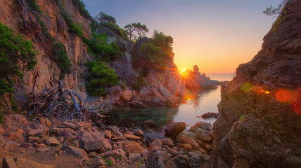 Scenery nature landscape of rocky bay on mediterranean sea at sunrise in Lloret de Mar, Costa Brava, Spain - obrazy, fototapety, plakaty