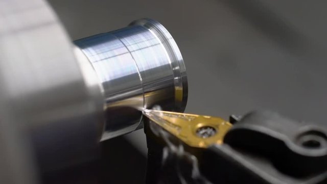 4K video of a lathe cutting and machining aluminium in a machine shop.