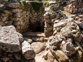 Sacred Source entrance archaeological site of Noddule in the megalithic circle and large circular hut in the new archaeological site in Sardinia , ITALY.