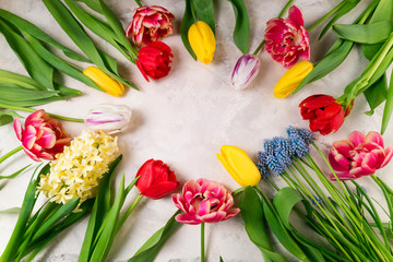 Spring flowers. Tulips, hyacinth, muscari on stone background. Holidays, Easter, happy birthday, anniwarsary, congratulations card concept.Flat lay. Top view, copy space