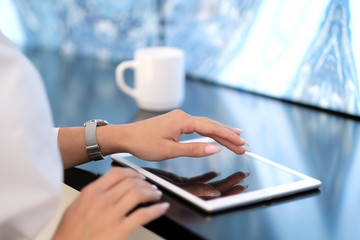 Close-up Of Young Businesswoman Looking At Graph On Digital Tablet