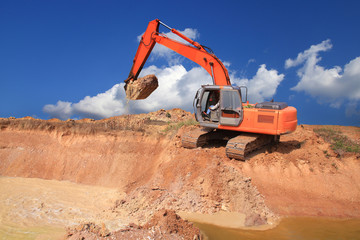 Excavator on a working platform on blue sky background