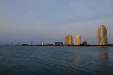 Fototapeta premium View of the sunset city from the pier in Pattaya