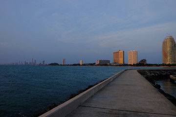 Fototapeta premium View of the sunset city from the pier in Pattaya