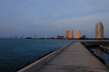 Fototapeta premium View of the sunset city from the pier in Pattaya