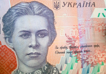 Ukrainian money. Banknote of Ukrainian hryvnia. Background of two hundred hryvnia banknotes, coins in piles, close-up