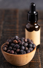 Juniper Berry Essential Oil on a Distressed Wooden Table