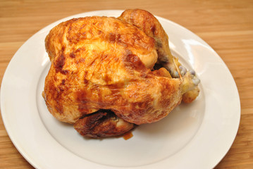 Whole Rotisserie Chicken on a White Plate