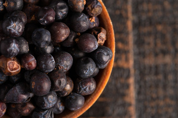 Bowl Full of Dried Juniper Berries on a Wooden Table