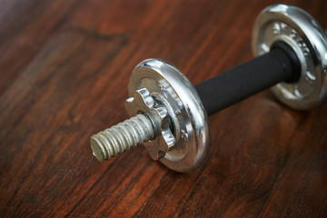 Dumbbell on wooden flooring background