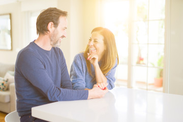 Romantic middle age couple sitting together at home