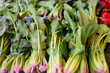 Bundles of fresh green spinach on farmer agricultural market