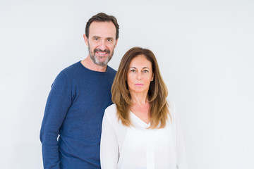 Beautiful middle age couple in love over isolated background Relaxed with serious expression on face. Simple and natural looking at the camera.