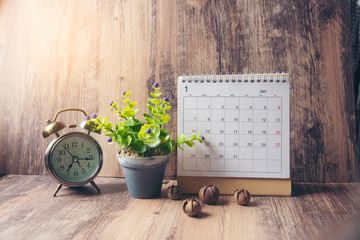 Desktop Calendar 2021 and clock place on wooden office desk. Calender for Planner to make timetable, agenda appointment, organization, management each date and year on table. Calendar Concept.