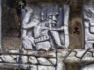 Fototapeta na wymiar Details of Mayan scenes engraved in stone. Aarcheological site, Xunantunich, Belize