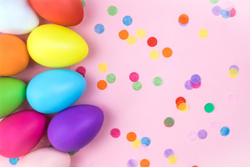 Colored Easter eggs on pink background. Flatlay.